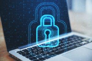 Ilustração de um computador com um cadeado holográfico sobre ele, representando a autenticação de dois fatores