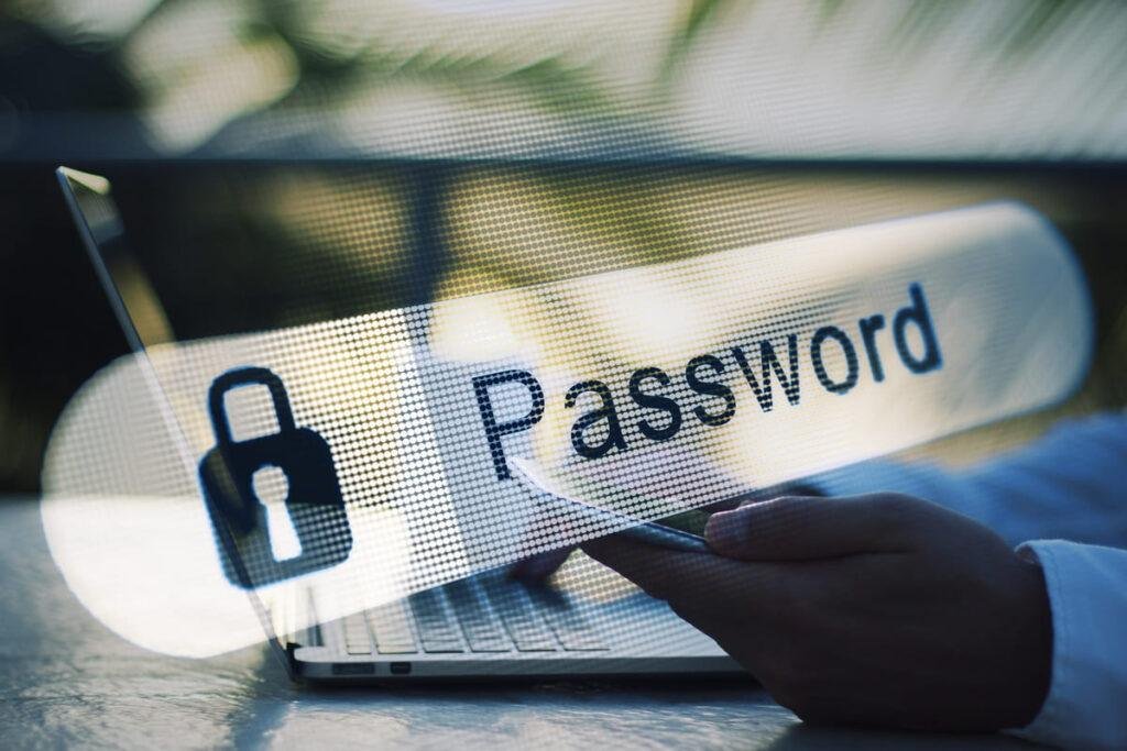 Imagem de uum notebook sobreposto pelo campo de senha em destaque